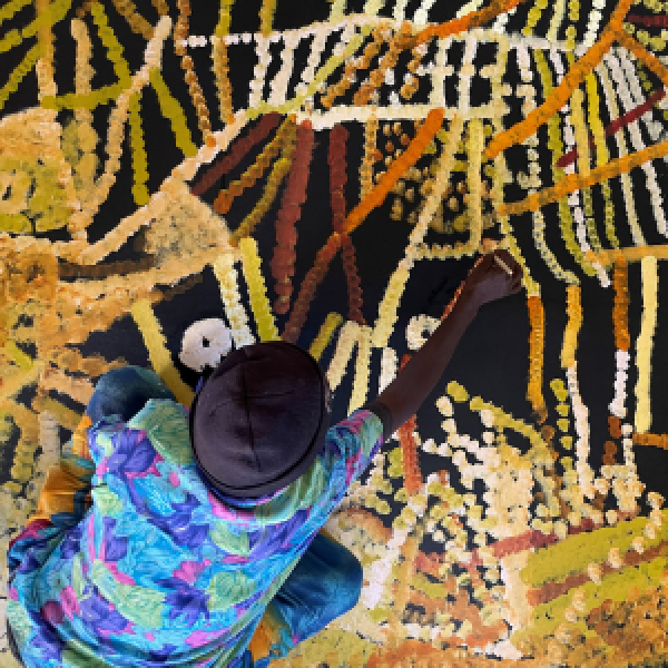 Indigenous artist paining at Utopia Art Centre in Central Australia